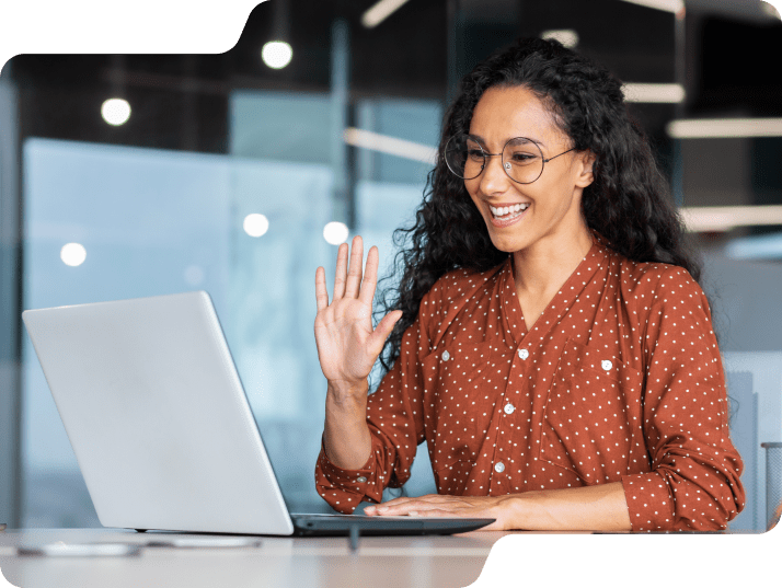 Woman waving on virtual call.