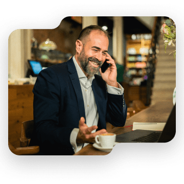 Man at his desk using a virtual attendant service.