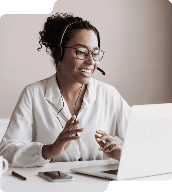 Woman on headset in front of computer