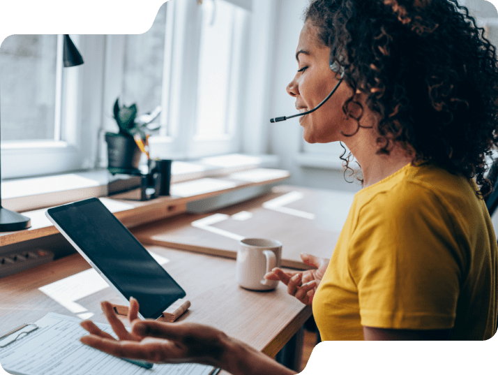 Woman on tablet with headset on.