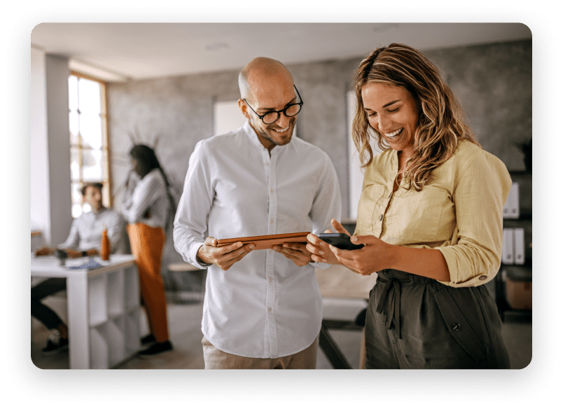 Man and woman holding tablets