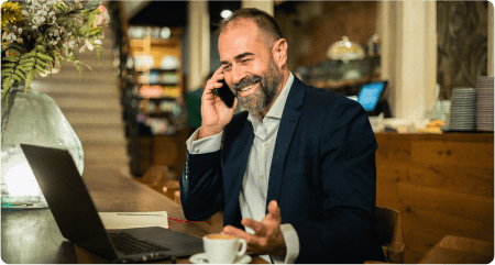 Man at his desk using a virtual attendant service.