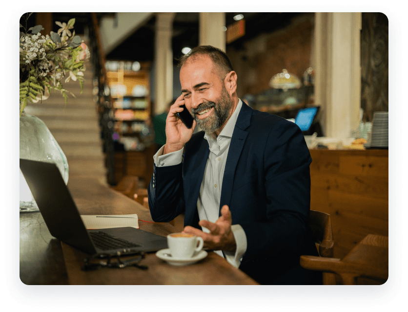 Man at his desk using a virtual attendant service.