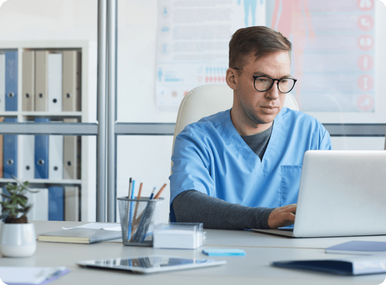 Clinician on laptop.