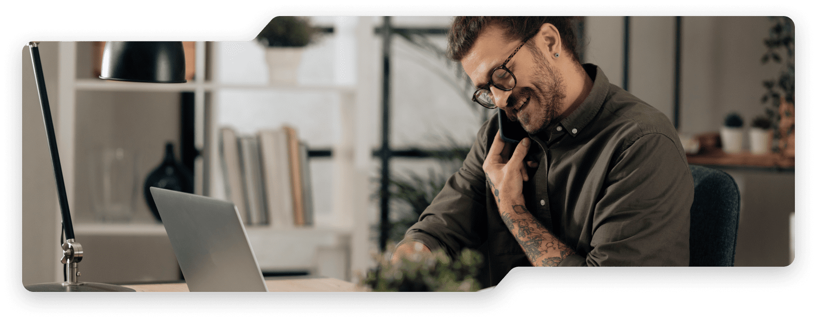 Man on phone while on laptop