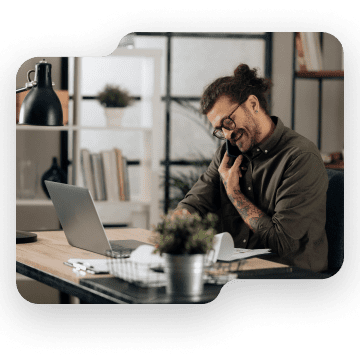 Man on phone while on laptop