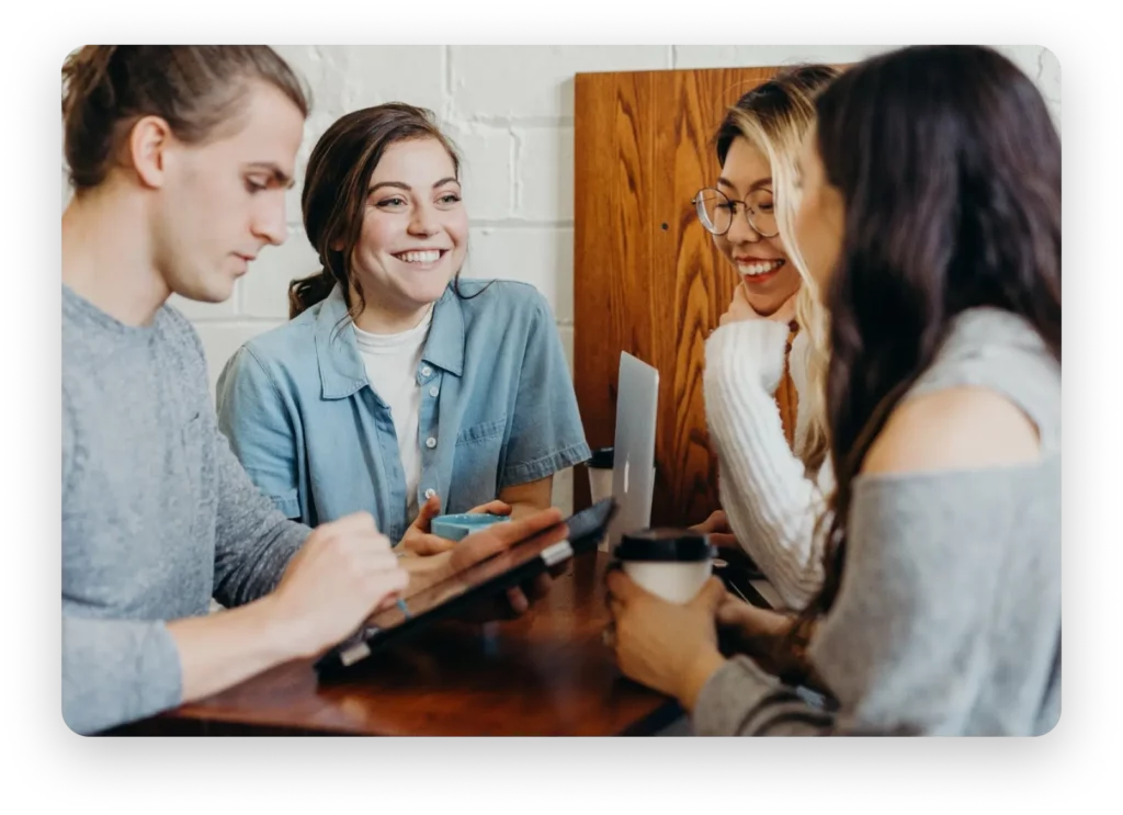 Colleagues gathered around devices.