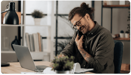 Man on phone while on laptop