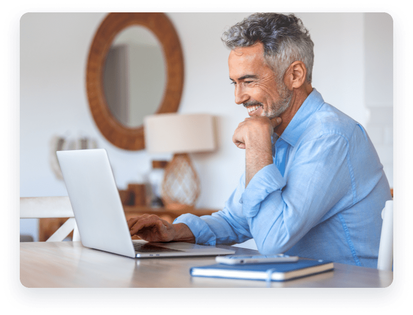 Man smiling looking at laptop
