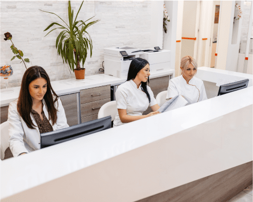 Colleagues at a clinic on computers.