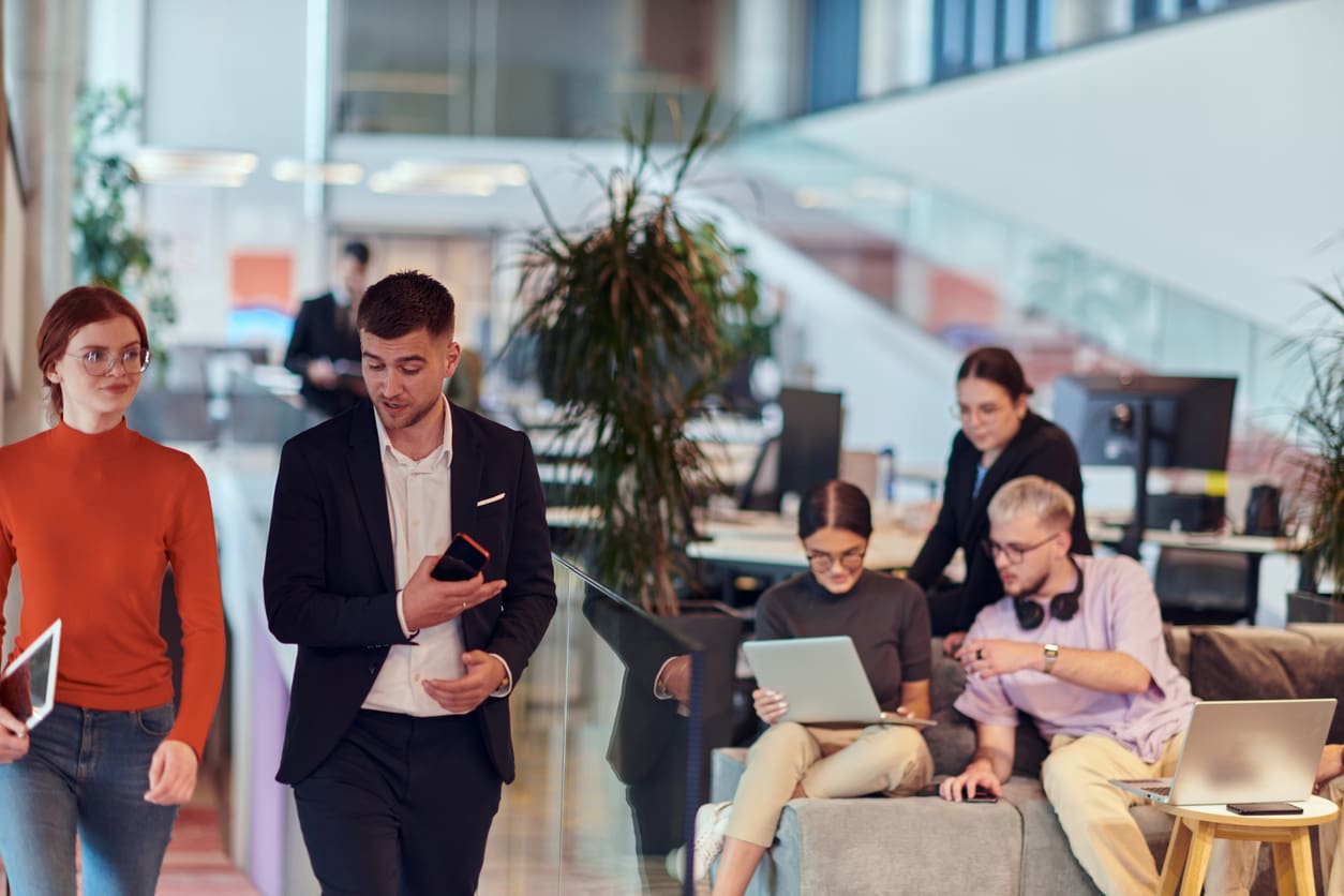 A small business team uses modern PBX and VoIP communication tools in a shared office space.