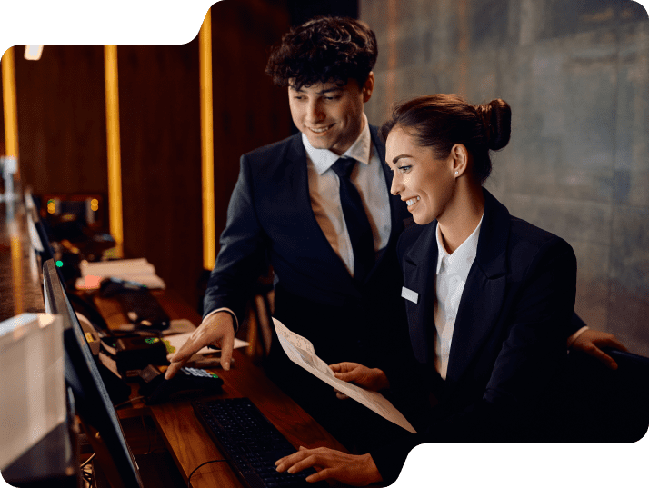 Front desk staff using hospitality VoIP solutions to manage guest check-ins and internal communication tools