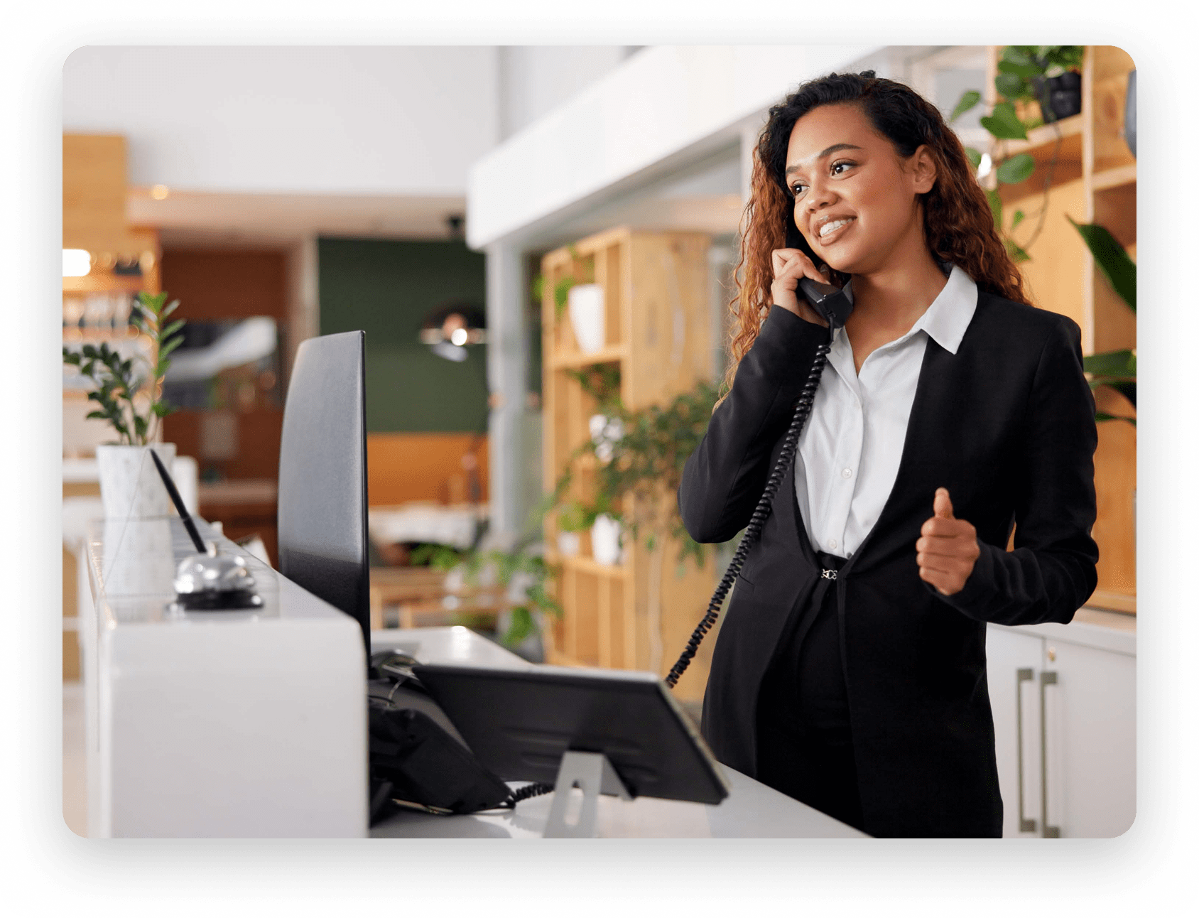 Receptionist using a hotel PBX system to manage front desk communications in a Canadian hospitality setting